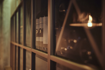Bottles of tasty wine in posh reastoraunt are stored on the shelf.