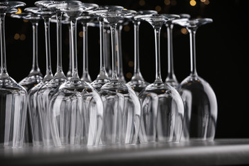 Empty glasses on grey table against blurred lights