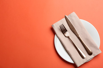 Elegant table setting on orange background, flat lay. Space for text