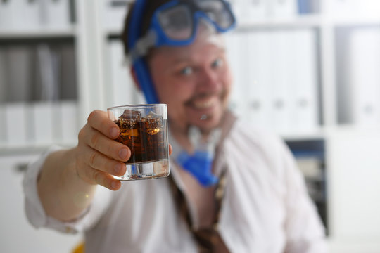 Man wearing suit and tie in goggles and snorkel hold in arm glass of cola at workplace in office closeup. Count days to leave annual day off workaholic resort idea ticket sale concept