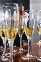 A large number of glasses with white wine at the bar. Wine tasting concept in a restaurant. Out of focus. Photo in the interior.
