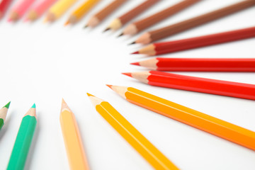 Composition with color pencils on white background