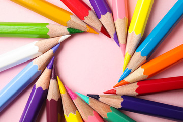 Fototapeta premium Frame made of color pencils on pink background, flat lay. Space for text