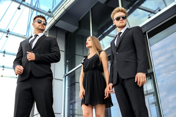 Famous celebrity with bodyguards outdoors