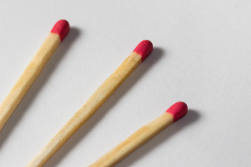 three diagonal matchsticks together on white background
