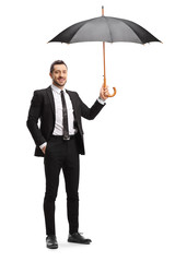 Businessman holding an open umbrella