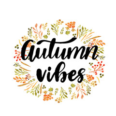 Hello autumn hand lettering phrase on orange watercolor maple leaf background