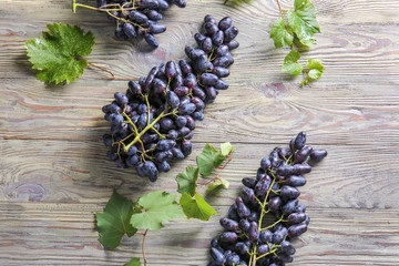 Tasty sweet grapes on wooden table