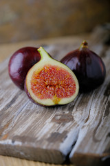 Fresh ripe figs and cut in half on a wooden table.