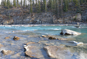 Glacier river rapids along rock cut