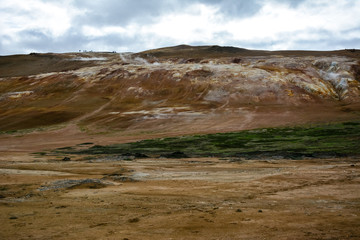 Leirhnjukur clay hill in Iceland with people on top, overcast day in summer , film effect with grain