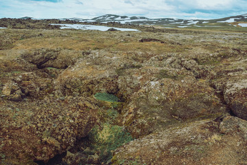 Leirhnjukur old magma field  and snow, overcast day in summer , film effect with grain