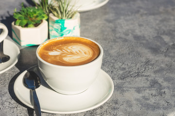 Flat white coffee on the table in the cafe