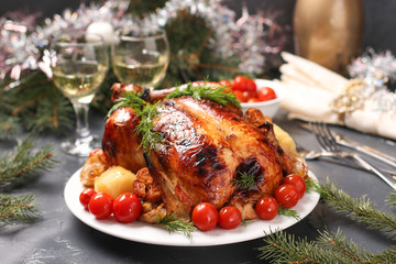 Baked chicken with honey, soy sauce, onion and garlic, served with potatoes and cherry tomatoes,...