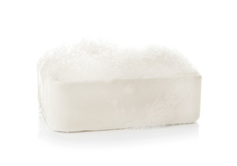 Soap bar with foam on white background