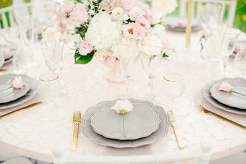 Amazing wedding table decoration with flowers on wooden tables for wedding dinner