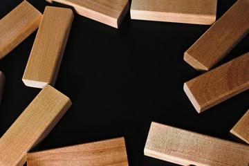 Frame of wooden blocks on a black background