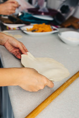 Close up hands while doing roll out doughs for patty,pastry and raviaoli