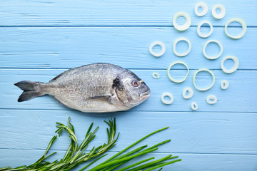 Composition with raw dorado fish on wooden background