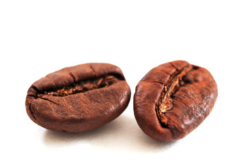 two coffee beans on white background