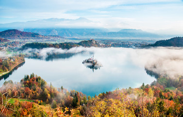 Picturesque views of the island on Lake Bled in the morning fog. Slovenia, Europe. Amazing places. Popular tourist atraction. Places of pilgrimage. (Meditation, travel, harmony - concept)