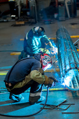Fototapeta na wymiar Industrial worker welder in factory workshop