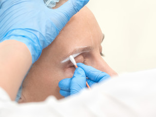 The architecture of the eyebrow.  Applying the contour. Coloring eyebrows with henna in the beauty salon.