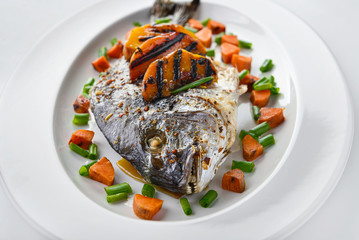 Prepared dorado fish on plate, closeup