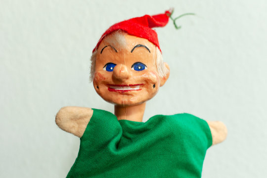 funny handmade Kasperle puppet on bright background