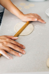Close up hands while doing roll out doughs for patty,pastry and raviaoli