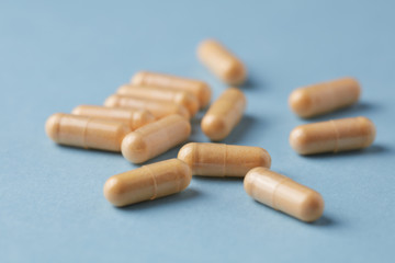 Coenzyme Q10 capsules. Dietary supplements. Bright paper background. Close up. 