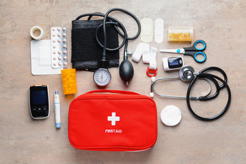 First aid kit on grey background