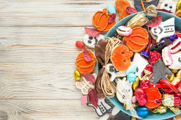 Halloween Jack o Lantern candy bowl with candy and halloween cookies Trick or Treat on old wooden background