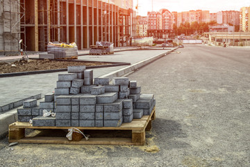 Paving bricks ready for construction work. Laying paving slabs on a city square, sidewalk