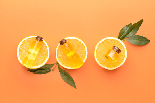 Composition with orange essential oil on color background