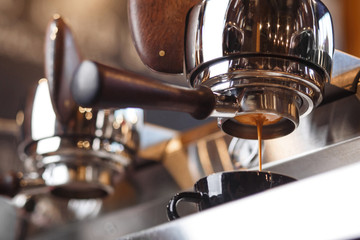Coffee machine preparing fresh espresso through the bottomless portafilter. Coffee extraction....