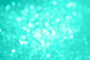 Abstract composition. Blurred photo of glitter with beautiful bokeh in turquoise. Defocused light.