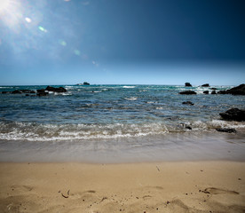 Summer photo of beach with blue sky and sun 