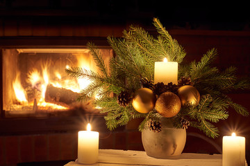 Christmas floral decoration in front of firepace.