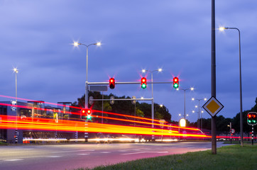 Slow shutter speed night photo of Dutch traffic lights with red brake lights at traffic light...