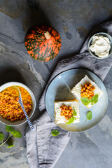 Slices of pumpkin cake topped with cream cheese  and Sea Buckthorn compote
