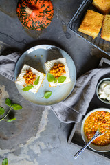 Slices of pumpkin cake topped with cream cheese  and Sea Buckthorn compote