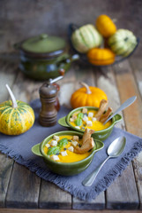 Creamy pumpkin soup topped with pumpkin 	