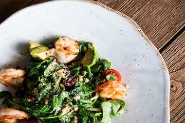 Fresh salad plate with shrimp, tomato and mixed greens. salad of shrimp, mixed greens.