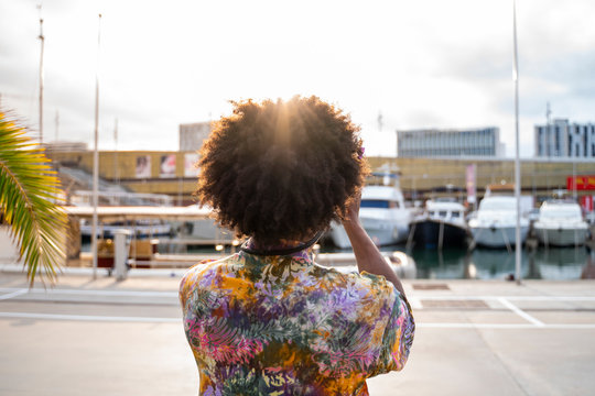 Rear view of man with a camera wearing colorful shirt