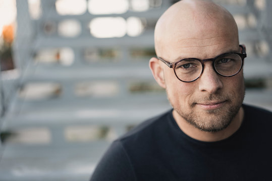 Portrait Of Bald Man With Beard Wearing Glasses