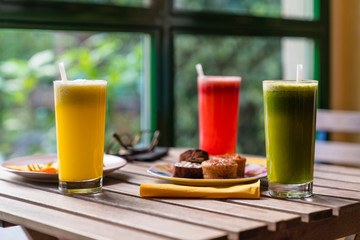 Variation of smoothies and cookies on wooden table