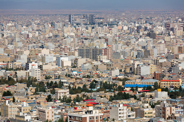Fototapeta na wymiar Panoramic view of the building density of Qom city, Iran. Dense urban development, unfinished houses, general view of the modern part of the city