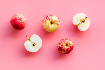 Red apples pattern on pink background top view