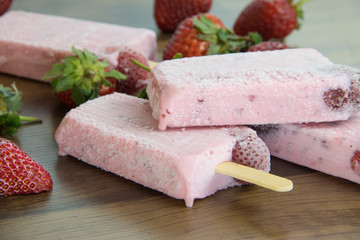 Ice lollipop with strawberries around